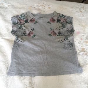 A T-shirt with flowers going down the sides